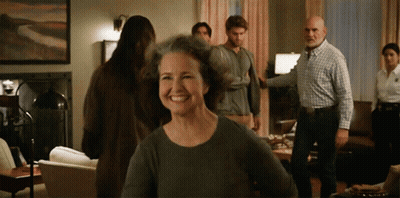 Group In Living Room With Smiling Woman GIF