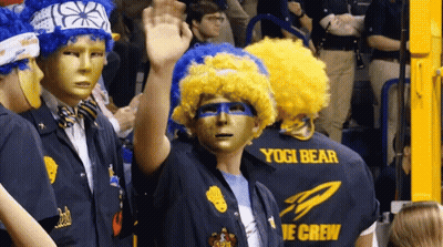 Group In Masks And Wigs Wearing Yogi Bear Shirts GIF