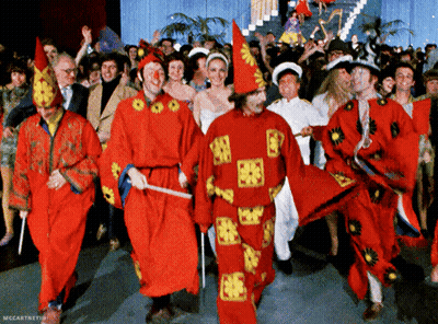 Group In Red And Yellow Costumes Dancing GIF