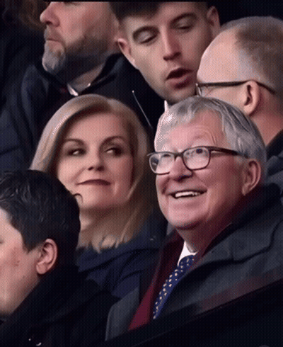 Group In Stadium With Man Wearing Glasses GIF