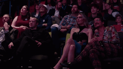 Group In Stadium With Man Wearing I Love You Sticker GIF