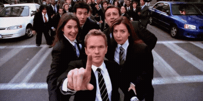 Group In Suits And Ties Standing Before Crowd GIF