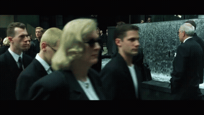 Group In Suits Walking By Waterfall GIF
