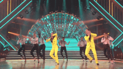 Group In Yellow Suits Dancing GIF