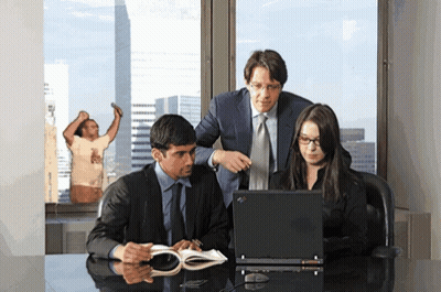 Group Looking At Laptop With Man In T-Shirt Behind GIF