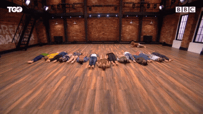 Group Lying On Backs On Wooden Floor With BBC GIF