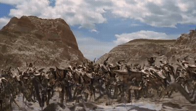 Group Of Animals In Desert With Mountains GIF