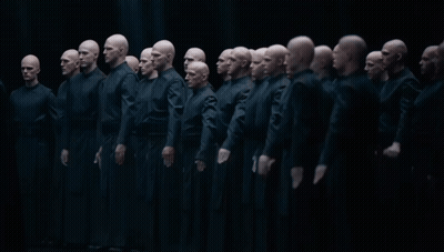 Group of Bald Men Standing in Dark Room