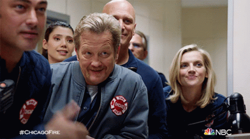 Group Of Chicago Firefighters Around Table GIF