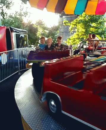 Group Of Children On Red Carnival Ride GIF