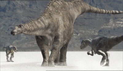 Group Of Dinosaurs Standing On Sand GIF