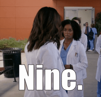 Group Of Doctors Standing Outside Building Saying Nine GIF