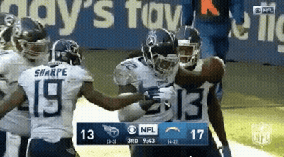 Group Of Football Players Holding Ball On Field GIF