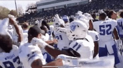 Group Of Football Players On Field With Crowd GIF