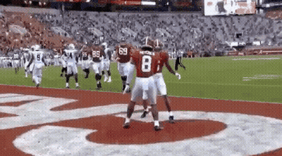 Group Of Football Players Standing On Field GIF