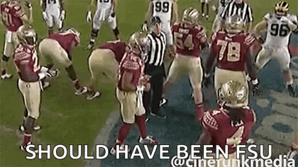 Group Of Football Players With Referee On Field GIF