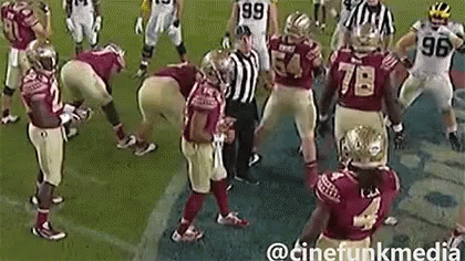 Group Of Football Players With Referee On Field GIF