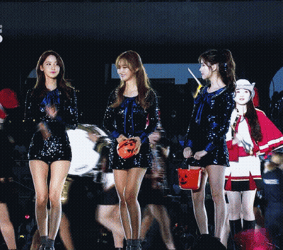 Group Of Girls Holding Pumpkin Bucket On Stage GIF
