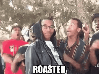 Group Of Men Around Hooded Man With Glasses GIF