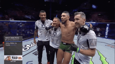 Group Of Men Around Man In UFC Uniform GIF
