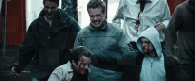 Group Of Men Around Man With Blood On Face GIF