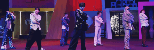 Group Of Men Dancing On Stage In Front Of Purple Background GIF