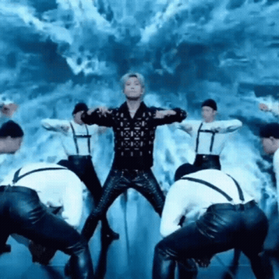 Group Of Men Dancing On Stage With Man In Middle GIF