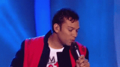 Group Of Men Dancing On Stage With Microphone GIF
