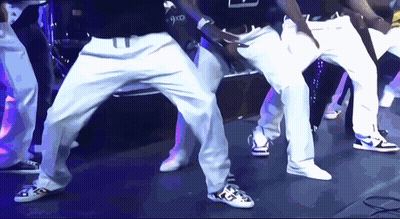 Group Of Men Dancing With 9X0 Shirt GIF