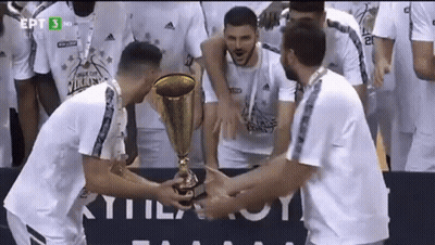 Group Of Men Holding Trophy In Front Of EPT Sign GIF