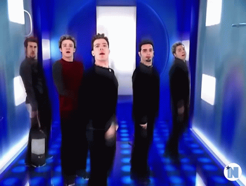 Group Of Men In Blue Hallway With Letter N GIF