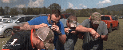 Group Of Men In Field One Wearing J. J. Jergens Shirt GIF