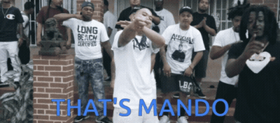 Group Of Men In Front Of Brick Building Saying That's Mando GIF