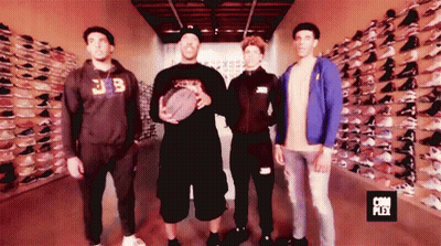 Group Of Men In Front Of Shoe Wall Saying Com Plex GIF