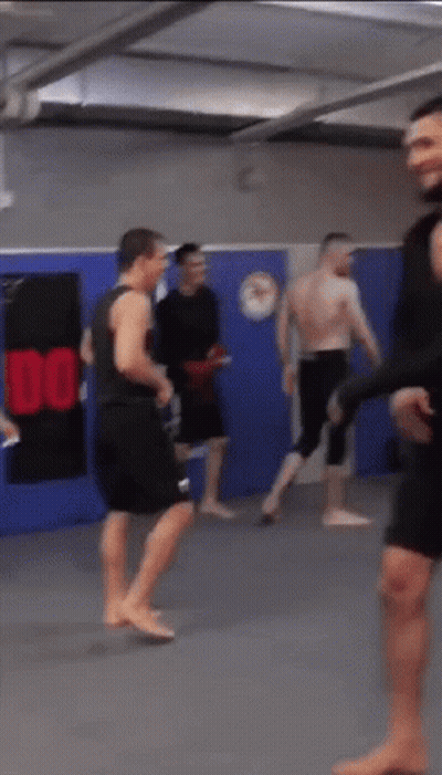 Group Of Men In Gym With Sign Saying 100 GIF
