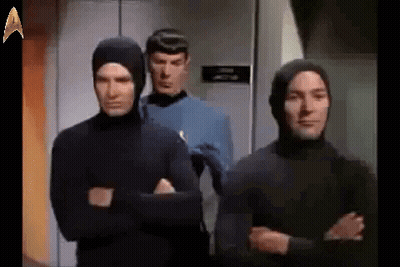 Group Of Men In Hooded Suits GIF
