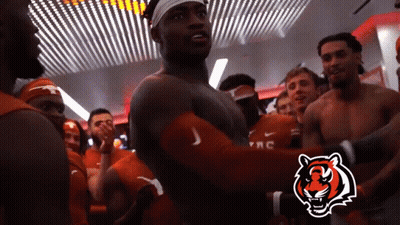 Group Of Men In Locker Room With Tiger Logo GIF