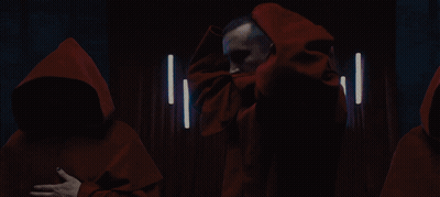 Group Of Men In Red Hooded Cloaks GIF