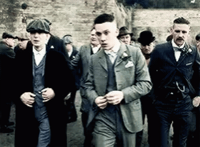 Group Of Men In Suits And Hats Standing Together GIF