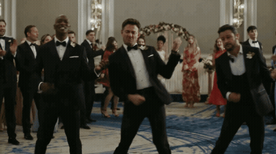 Group Of Men In Tuxedos Dancing GIF