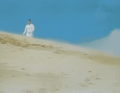 Group Of Men In White Walking Down Hill GIF