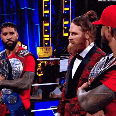 Group Of Men In Wrestling Ring With Red Shirt GIF