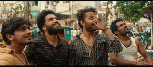 Group Of Men Looking Up At Sky On Street GIF