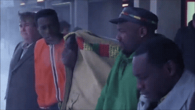 Group Of Men One In Green Jacket GIF