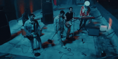 Group Of Men Playing Instruments On Stage GIF