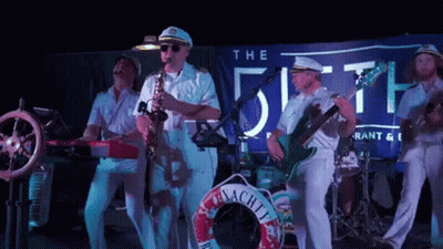 Group Of Men Playing Instruments Under The Fifth Banner GIF