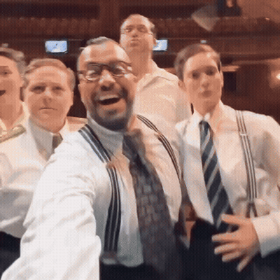 Group Of Men Posing One In Suspenders GIF