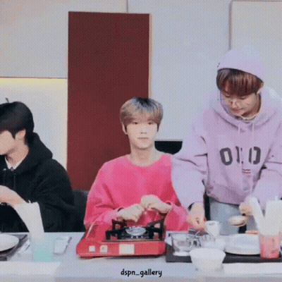 Group Of Men Preparing Food At Table GIF