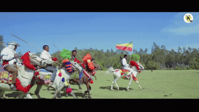 Group Of Men Riding Horses With Flag GIF