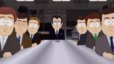 Group Of Men Sitting Around Table With Man In Suit GIF